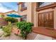 Inviting front entrance featuring a beautiful solid wood front door, outdoor seating, and a well-maintained garden at 905 Possum Hill St, Henderson, NV 89014