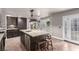 Well-lit kitchen with a large island, stainless steel appliances, and white French doors at 905 Possum Hill St, Henderson, NV 89014
