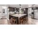 Modern kitchen boasts a large island with counter seating, stainless steel appliances, and dark wood cabinetry at 905 Possum Hill St, Henderson, NV 89014