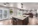 Open concept kitchen featuring a center island with seating and seamless access to the Gathering room at 905 Possum Hill St, Henderson, NV 89014