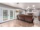 Living room with french doors leading to pool and wood-look floors at 905 Possum Hill St, Henderson, NV 89014