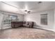 Bright, open living room features tile floors, ample natural light, and a large sectional sofa for comfortable living at 905 Possum Hill St, Henderson, NV 89014
