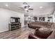 Open concept living room with adjacent kitchen, bar seating, and an entertainment center at 905 Possum Hill St, Henderson, NV 89014