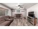 Comfortable living room features ceiling fan, brick fireplace and wood-look floors at 905 Possum Hill St, Henderson, NV 89014
