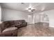 Spacious living room features tile floors and a comfortable sectional couch perfect for relaxing and entertaining at 905 Possum Hill St, Henderson, NV 89014