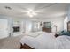 Bright main bedroom featuring neutral carpet, a fireplace, and a large dresser at 905 Possum Hill St, Henderson, NV 89014