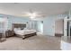 Large main bedroom featuring soft blue walls, neutral carpet and access to a bathroom and fireplace at 905 Possum Hill St, Henderson, NV 89014