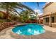 A backyard pool surrounded by lush, mature landscaping creates a relaxing and inviting atmosphere at 905 Possum Hill St, Henderson, NV 89014