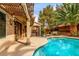 A backyard pool surrounded by lush landscaping and comfortable seating areas at 905 Possum Hill St, Henderson, NV 89014