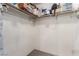 Unorganized walk-in closet with clothing, boxes, and other items on the shelves and racks at 905 Possum Hill St, Henderson, NV 89014