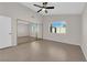 Spacious bedroom with tile floors, ceiling fan, and mirrored closet doors at 908 Coral Isle Way, Las Vegas, NV 89108