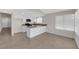 Open kitchen features white cabinets, a center island and tile flooring at 908 Coral Isle Way, Las Vegas, NV 89108