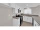 Well-lit kitchen with white cabinetry, gray countertops, and stainless-steel appliances at 908 Coral Isle Way, Las Vegas, NV 89108