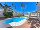 Backyard view featuring a bright blue pool, covered patio and mature landscaping at 9541 Summersweet Ct, Las Vegas, NV 89123