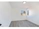 Bedroom with wood-style flooring and a pair of bright windows at 9541 Summersweet Ct, Las Vegas, NV 89123