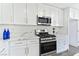 Modern kitchen boasts marble countertops and stainless steel appliances at 9541 Summersweet Ct, Las Vegas, NV 89123