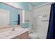 Bathroom featuring a tub, shower with a blue curtain, and a single sink at 9624 Twelve Pins Dr, Las Vegas, NV 89129
