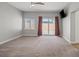 Bedroom featuring natural light, carpet flooring, ceiling fan and sliding glass doors at 9624 Twelve Pins Dr, Las Vegas, NV 89129