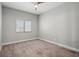 Neutral bedroom with a ceiling fan and a window at 9624 Twelve Pins Dr, Las Vegas, NV 89129