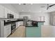 Open kitchen featuring stainless steel appliances, white cabinets and breakfast bar at 9624 Twelve Pins Dr, Las Vegas, NV 89129