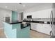 Updated kitchen with white cabinets, granite countertops, stainless steel appliances, and a breakfast bar at 9624 Twelve Pins Dr, Las Vegas, NV 89129