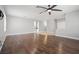 Spacious living room with hardwood floors, ceiling fan, neutral walls, and transition to tiled flooring at 9624 Twelve Pins Dr, Las Vegas, NV 89129