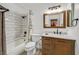 Bathroom features a shower-tub combination and wooden vanity with marble counter at 9815 Ramhorn Canyon St, Las Vegas, NV 89183