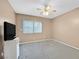 Neutral toned bedroom with carpet, ceiling fan and window with blinds at 9815 Ramhorn Canyon St, Las Vegas, NV 89183