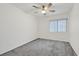 Carpeted bedroom featuring a ceiling fan and a window with blinds at 9815 Ramhorn Canyon St, Las Vegas, NV 89183