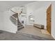 Grand foyer showcasing a curved staircase, a tile floor, an arched window, and ample natural light at 9815 Ramhorn Canyon St, Las Vegas, NV 89183