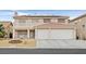 Charming two-story home showcasing a cozy balcony, front-facing two-car garage, and tasteful landscaping at 9815 Ramhorn Canyon St, Las Vegas, NV 89183