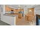 Spacious kitchen with wood cabinets, granite countertops, stainless-steel appliances, and hardwood flooring at 9815 Ramhorn Canyon St, Las Vegas, NV 89183