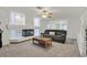 Bright living room featuring plush carpeting, a sleek fireplace, and a comfortable sofa at 9815 Ramhorn Canyon St, Las Vegas, NV 89183