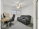 Office with natural light, desk with computer, and gray loveseat at 9815 Ramhorn Canyon St, Las Vegas, NV 89183