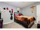Unique bedroom with gray walls and carpet, decorated with various wall items at 997 N Christy Ln, Las Vegas, NV 89110
