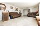 Open living room with tile floors, featuring sofas and wood accents at 997 N Christy Ln, Las Vegas, NV 89110