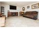 Spacious living room featuring a sofa, tile floors, and rustic wood accents at 997 N Christy Ln, Las Vegas, NV 89110