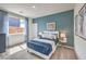 Stylish bedroom features a blue accent wall and bright natural light at 1019 Gentle Swan St # 693, Henderson, NV 89011