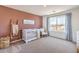 Bright Bedroom featuring a crib, rocking chair, and decorative accents at 1019 Gentle Swan St # 693, Henderson, NV 89011