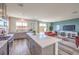 Open-concept kitchen with a large island and views of the living and dining areas at 1019 Gentle Swan St # 693, Henderson, NV 89011