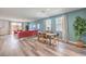 Open-concept living and dining area with sleek wood floors and plenty of natural light from large windows at 1019 Gentle Swan St # 693, Henderson, NV 89011