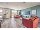 Cozy living room with a modern sofa, a large TV, and sliding doors to a patio at 1019 Gentle Swan St # 693, Henderson, NV 89011