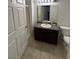Bathroom with dark wood cabinets, granite countertop, and a shower with glass doors at 10245 S Maryland Pkwy # 2216, Las Vegas, NV 89183