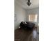 Bedroom with laminate flooring and window with blinds at 10245 S Maryland Pkwy # 2216, Las Vegas, NV 89183