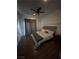 Bedroom with a ceiling fan, hardwood floors, and window with curtains at 10245 S Maryland Pkwy # 2216, Las Vegas, NV 89183