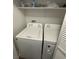 A laundry room features a white washer and dryer set, with some bottles and cleaning supplies on the shelf at 10245 S Maryland Pkwy # 2216, Las Vegas, NV 89183