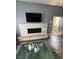 Living room featuring a fireplace under a flat screen TV and a unique coffee table at 10245 S Maryland Pkwy # 2216, Las Vegas, NV 89183