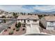 Aerial view of the home and neighborhood with mountain views and a tile roof at 10508 Waking Cloud Ave, Las Vegas, NV 89129