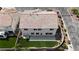 Aerial view of the home with a colorful tile roof, green lawn and mature landscaping at 10508 Waking Cloud Ave, Las Vegas, NV 89129