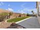 Backyard features artificial turf, a stone border, concrete patio and brick wall at 10508 Waking Cloud Ave, Las Vegas, NV 89129